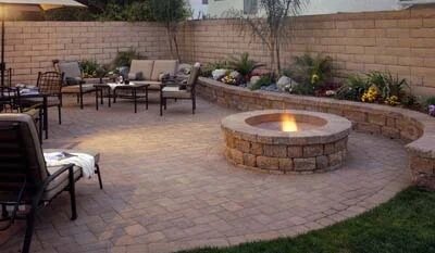 Beautiful yard with stone wall and fire pit.